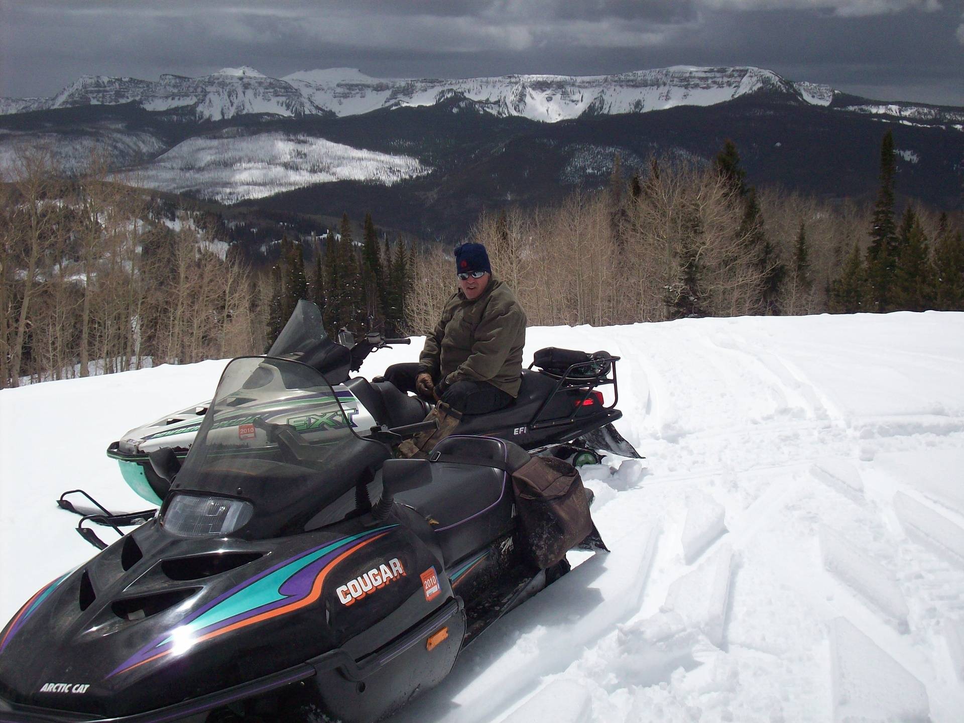 Welder Ranch and outfitter Services Snowmobile with Background
